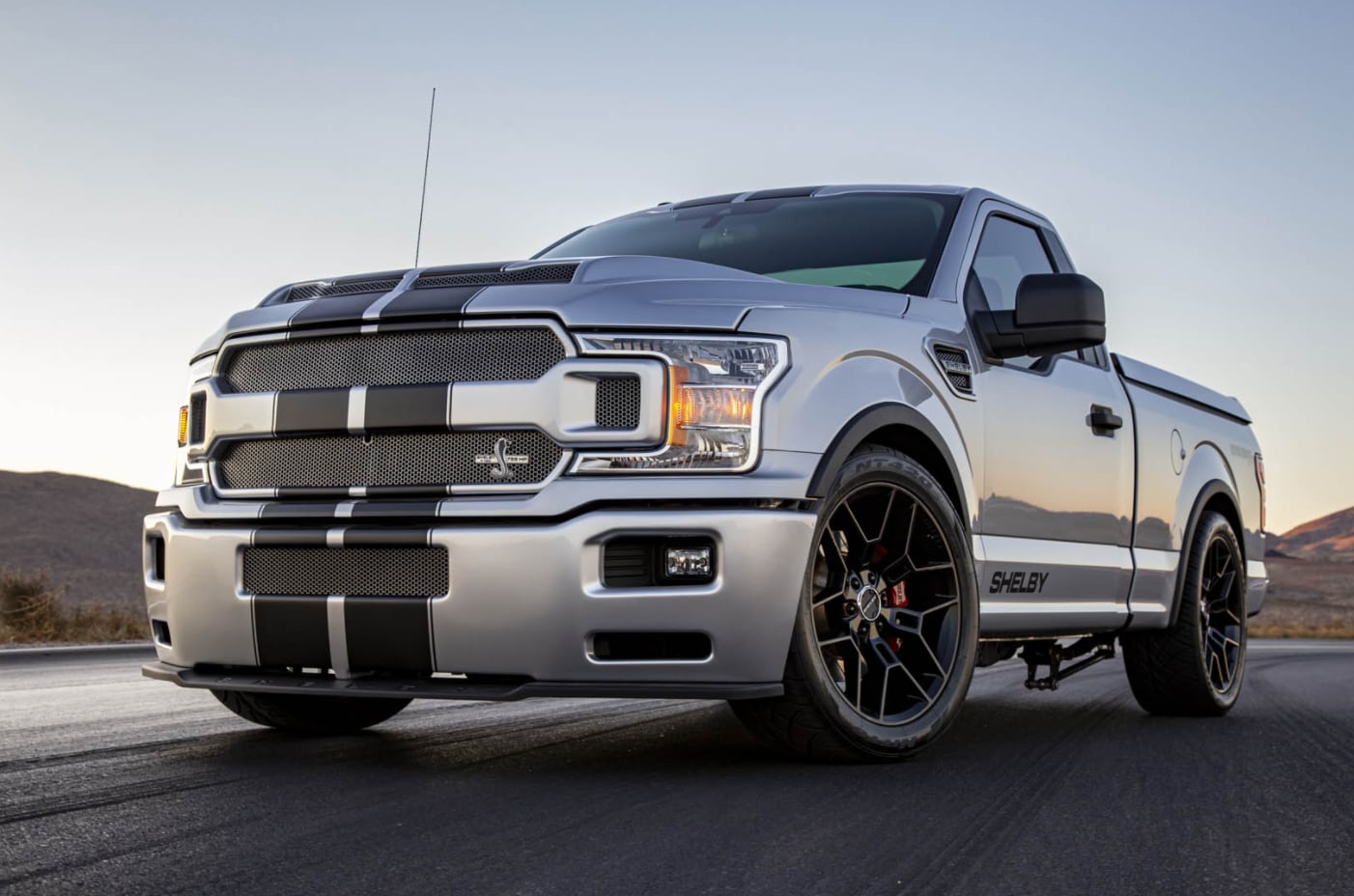 A silver new 2022 Ford Shelby F-150 Super Snake races down a wet road