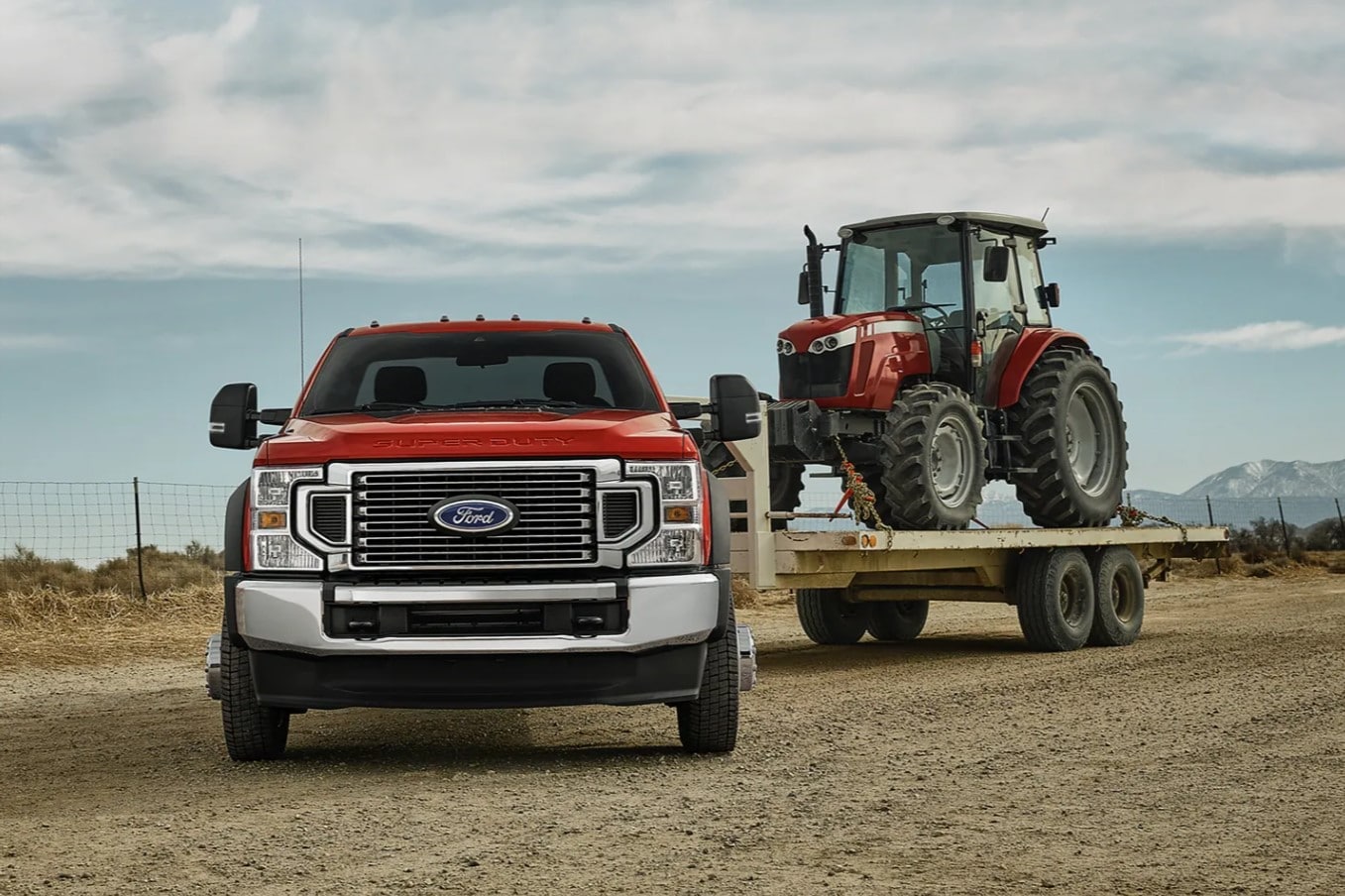 A new Ford Super Duty pulling a tractor