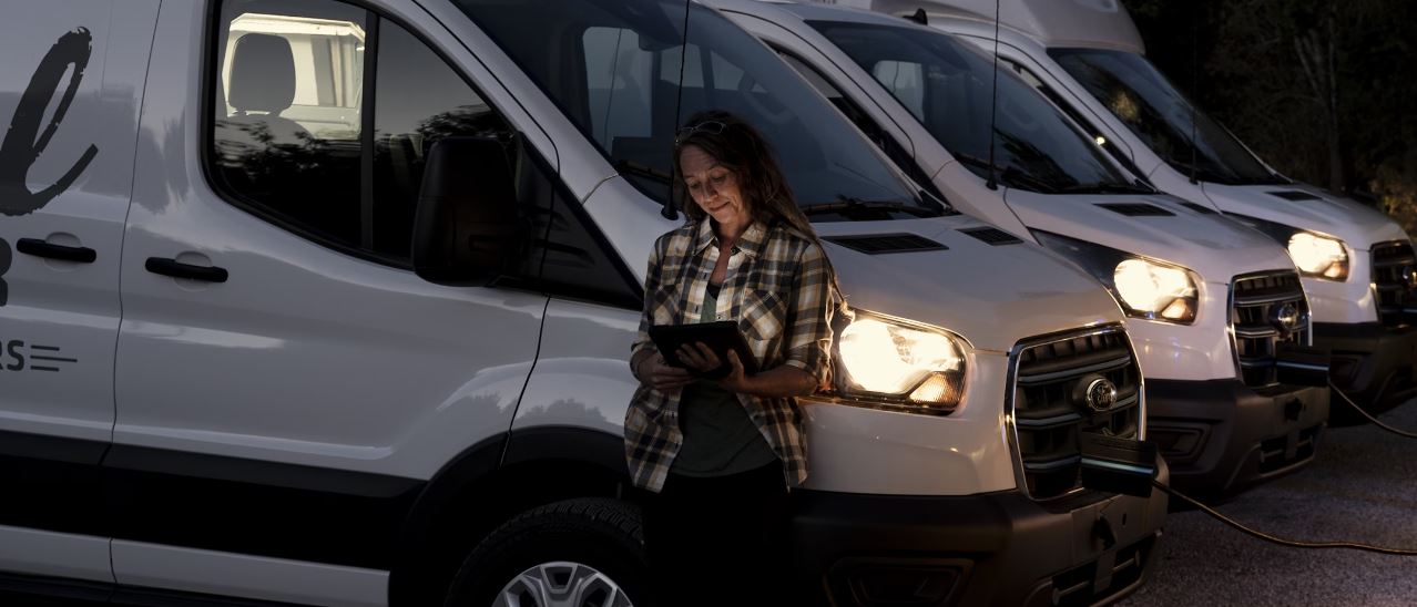 A new Ford E-Transit charging outside a buisness.