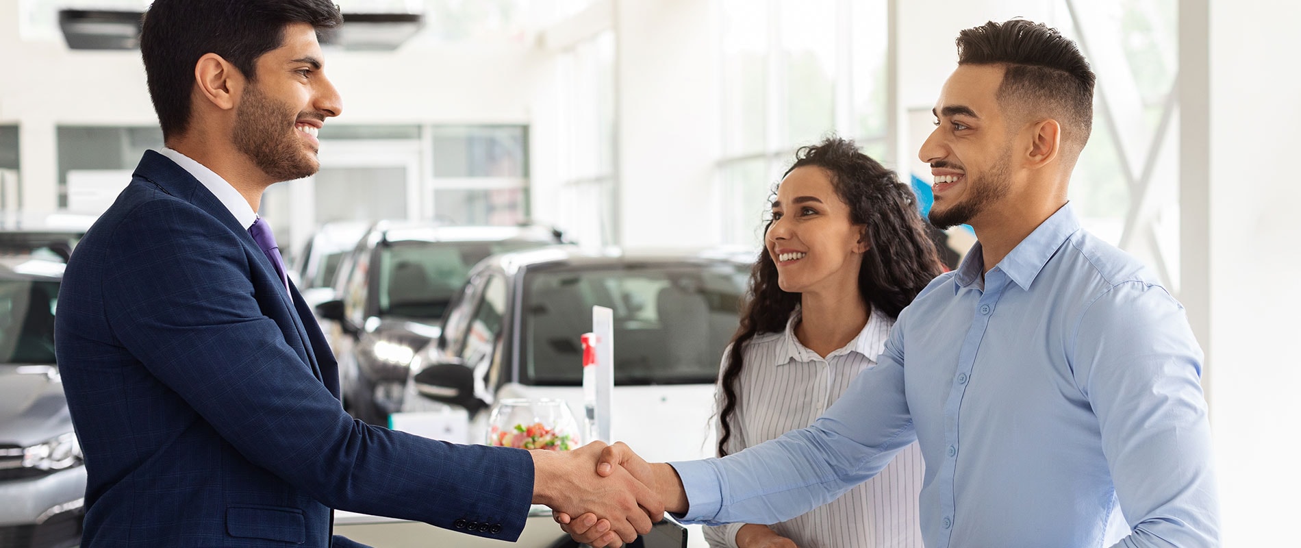Customers happily accepting employee pricing at their local Ford dealer