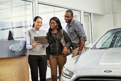 Ford dealership finance center assisting customer