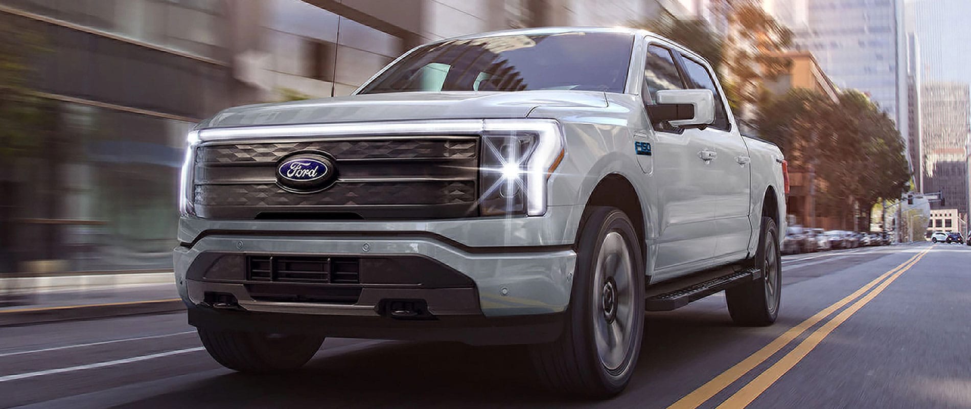 2025 Ford F-150 Lightning driving down a city street