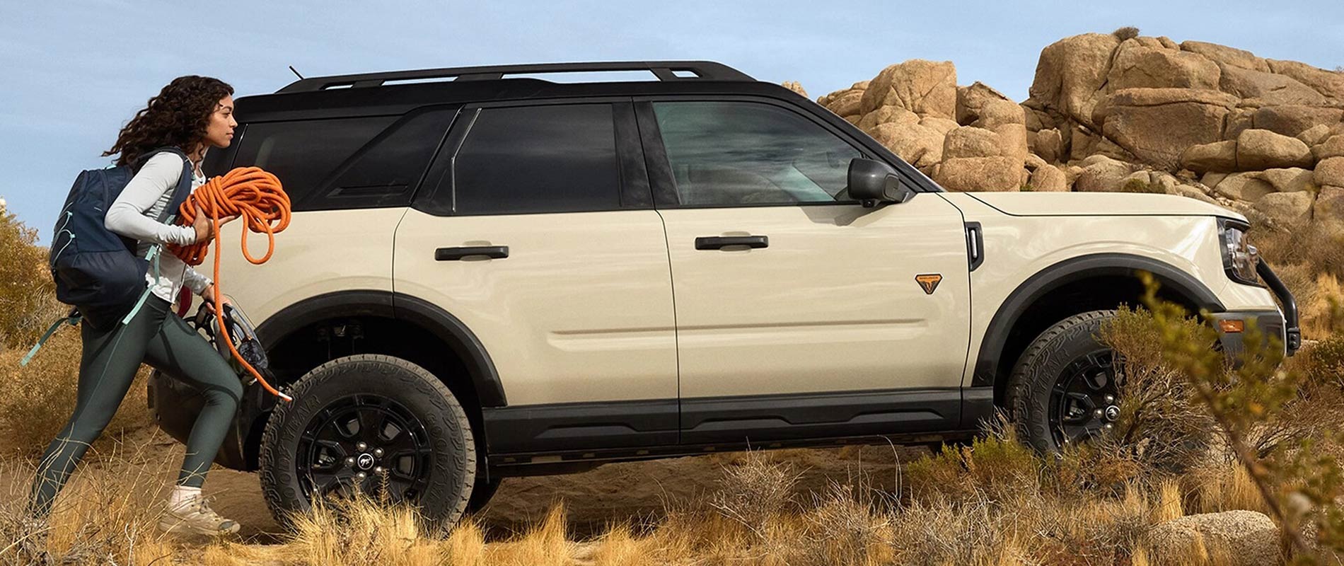 Bronco Sport Models for Sale in Colorado Springs, CO Young woman rock climbing with her Ford Bronco Sport