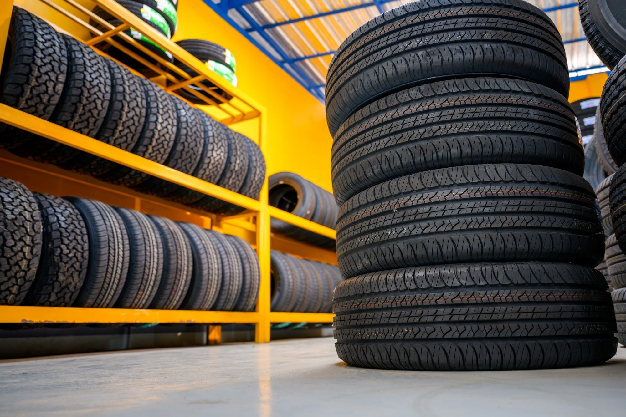 Tires stacked inside of a quick lane service center.