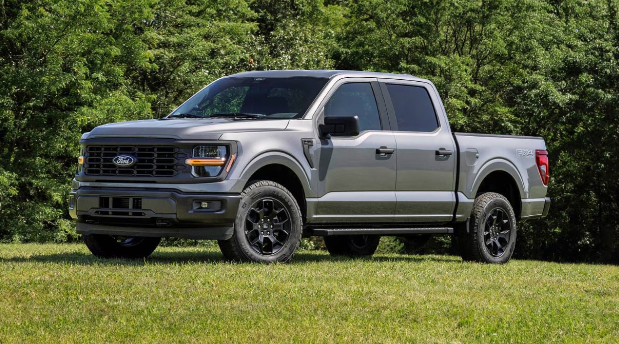 A Ford-150 truck parked in the grass A Ford-150 truck parked in the grass
