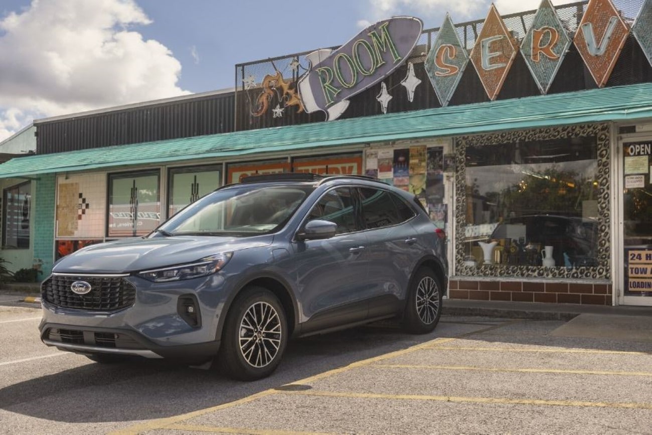 A Ford Escape parked in front of a small business.
