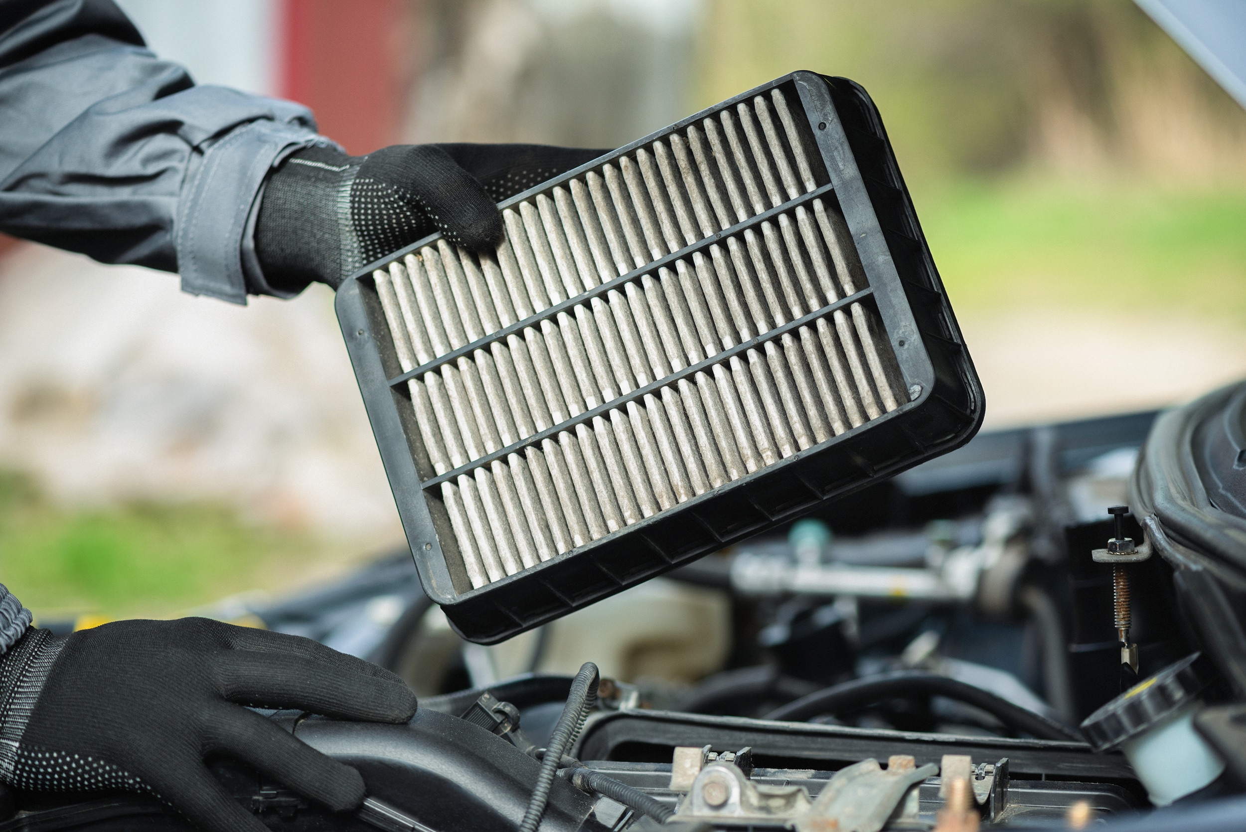A car air filter being replaced.
