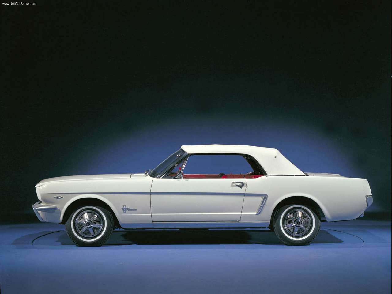 A 1964 white Ford Mustang on display.