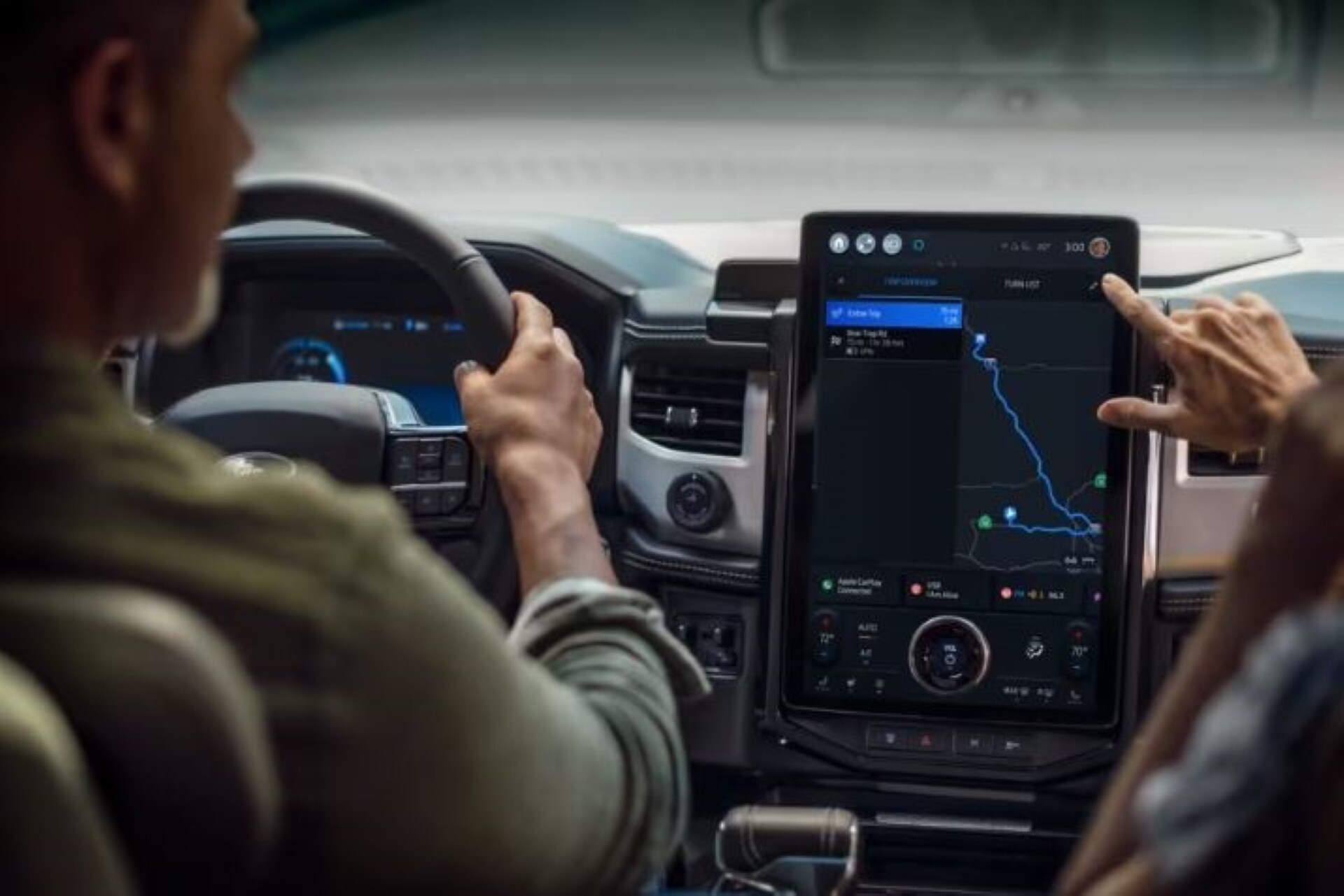 Someone Pointing at direction displayed on the screen showcasing Ford technology.