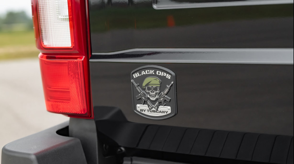 A close up of the Black Ops Emblem featuring a skull and cross bones that is on the back tailgate of the all black 2022 Ford Black Ops F-150