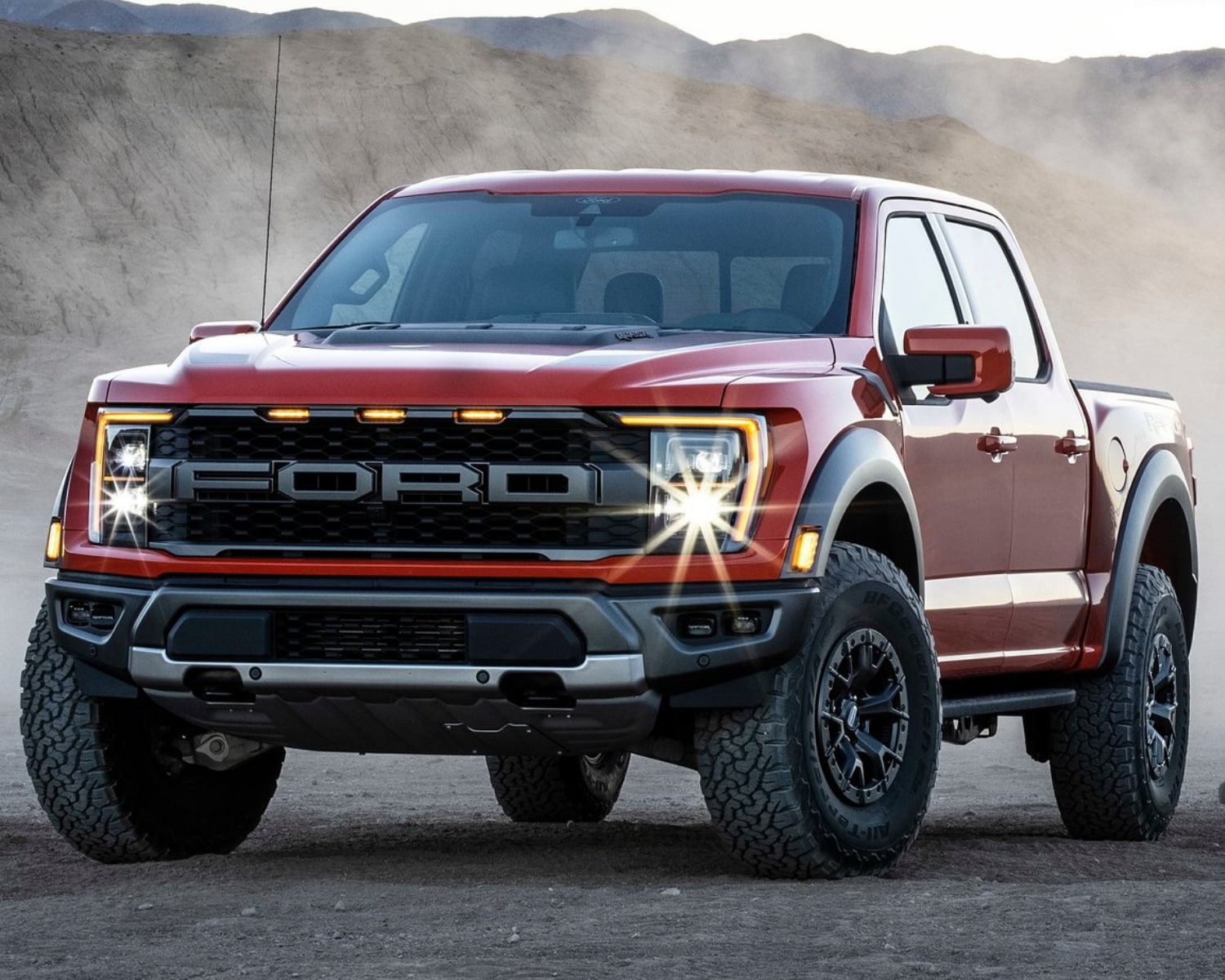 Front exterior view of the all-new 2021 Ford Raptor with the LED head lights glaring into the camera lens