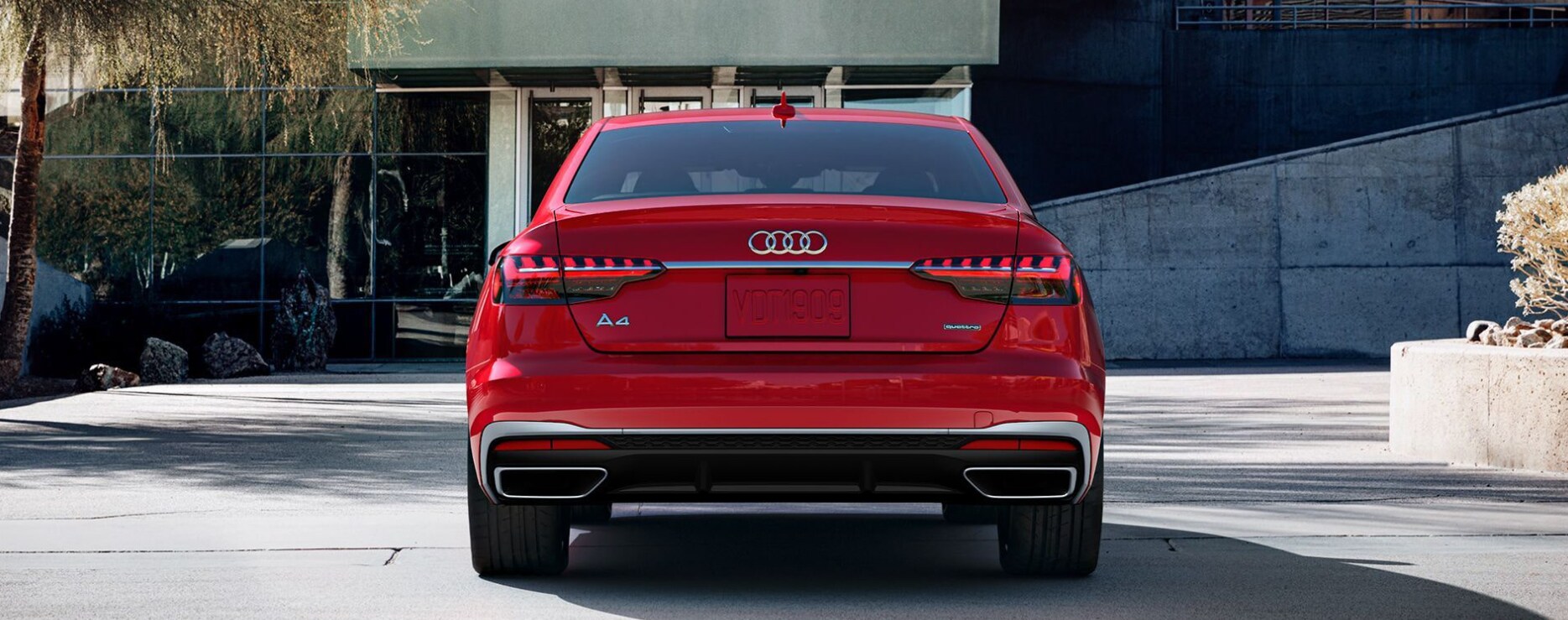 A view of the back of a red 2023 Audi A4