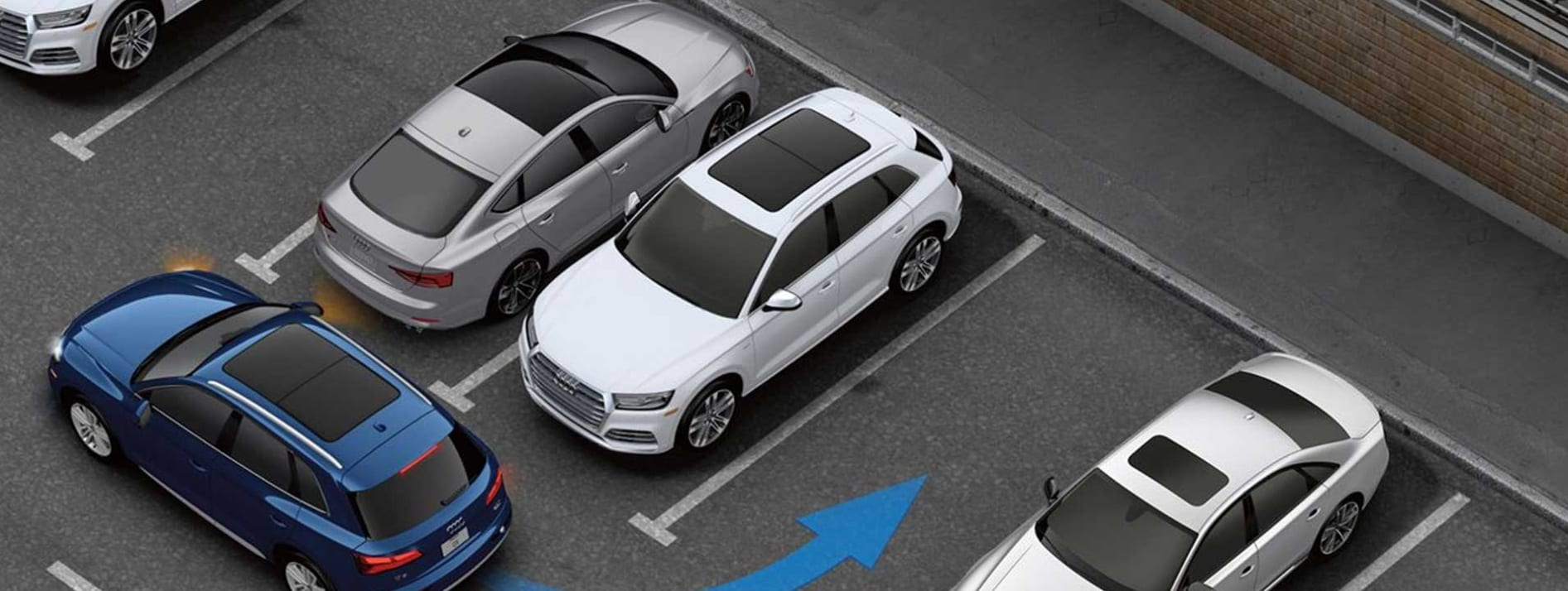 An overhead view of a blue 2023 Audi Q5 that is about to park using park assist