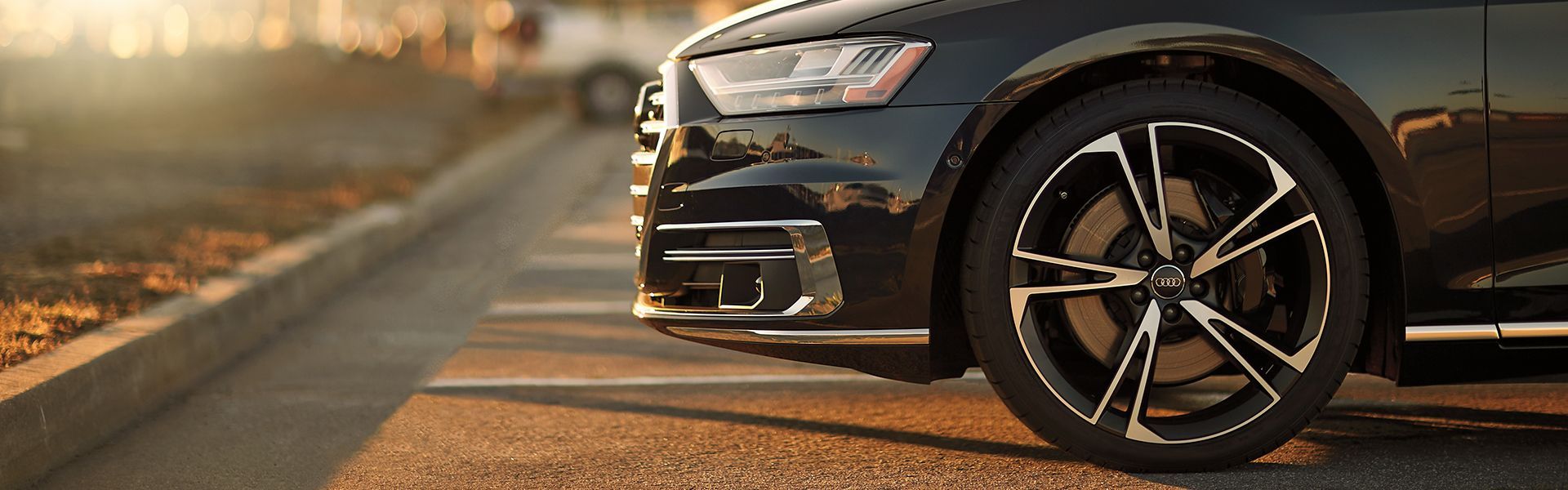 A parked Audi with new wheels on.