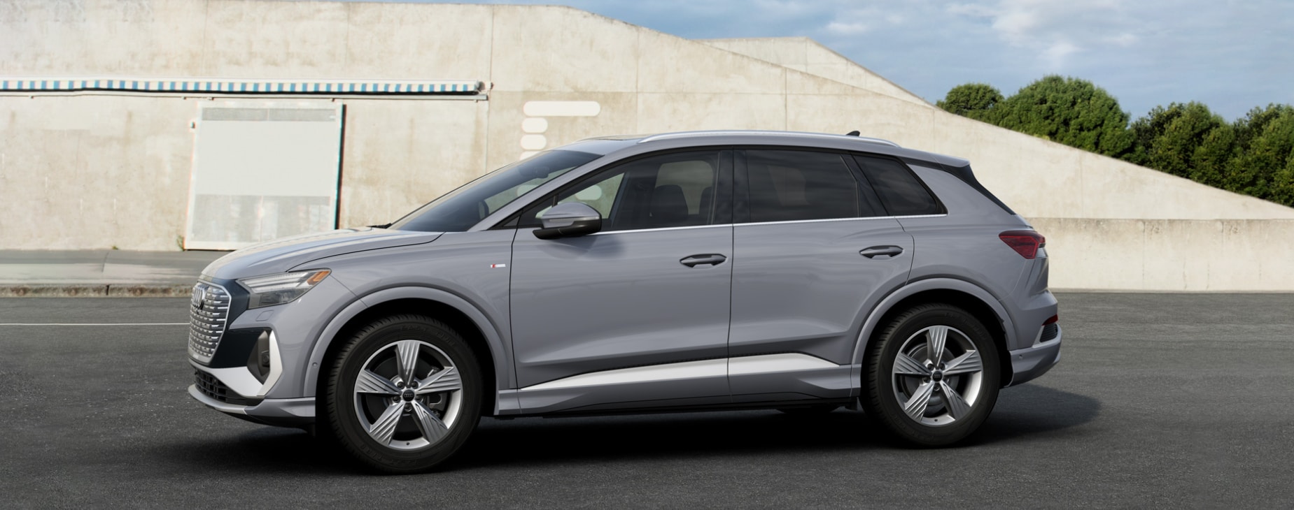 A profile view of a light gray 2023 Audi Q4 e-tron