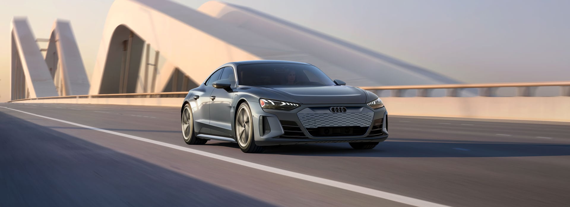 An Audi e-tron GT driving down a road