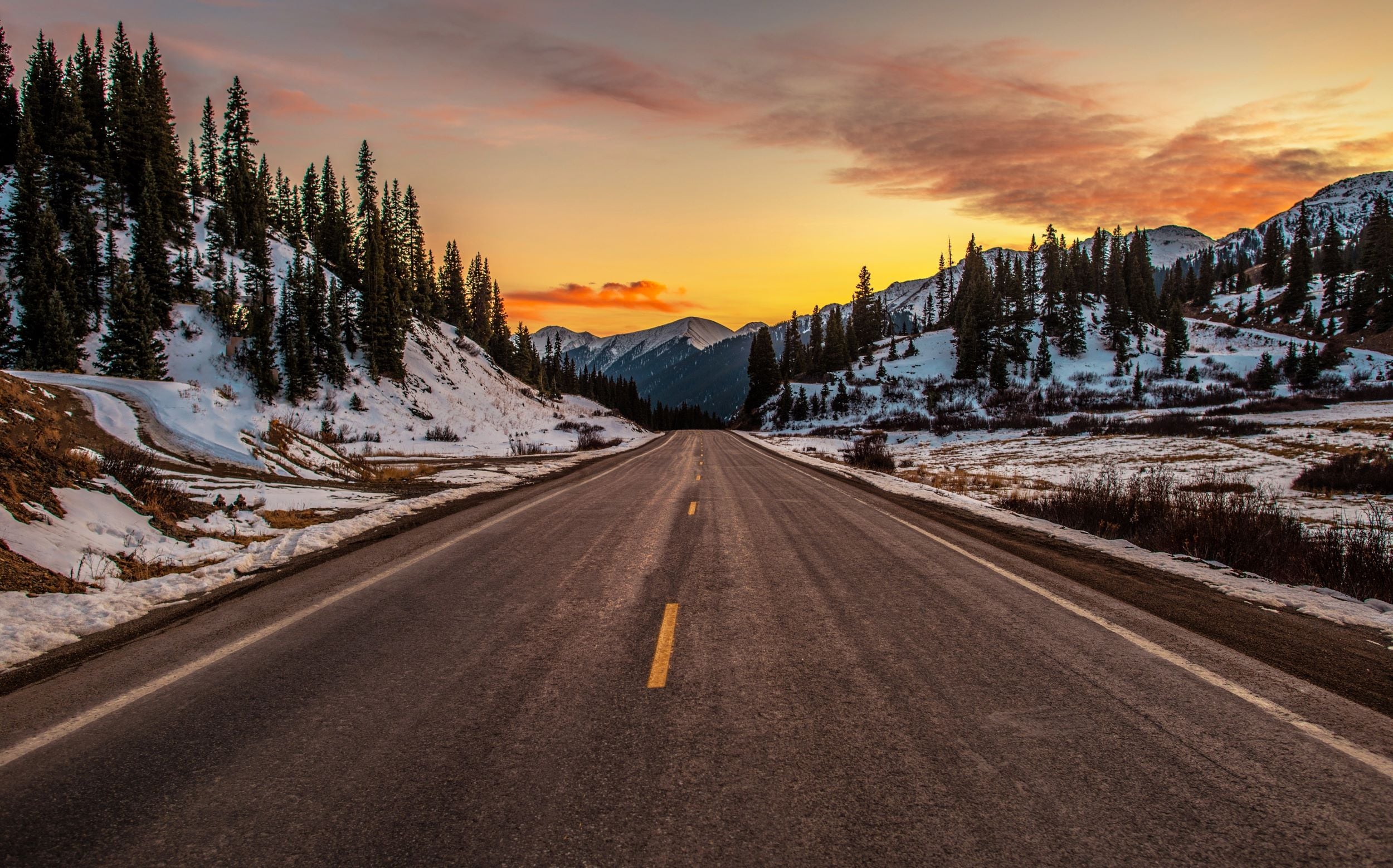 A sunset over a mountain road in Colorado.