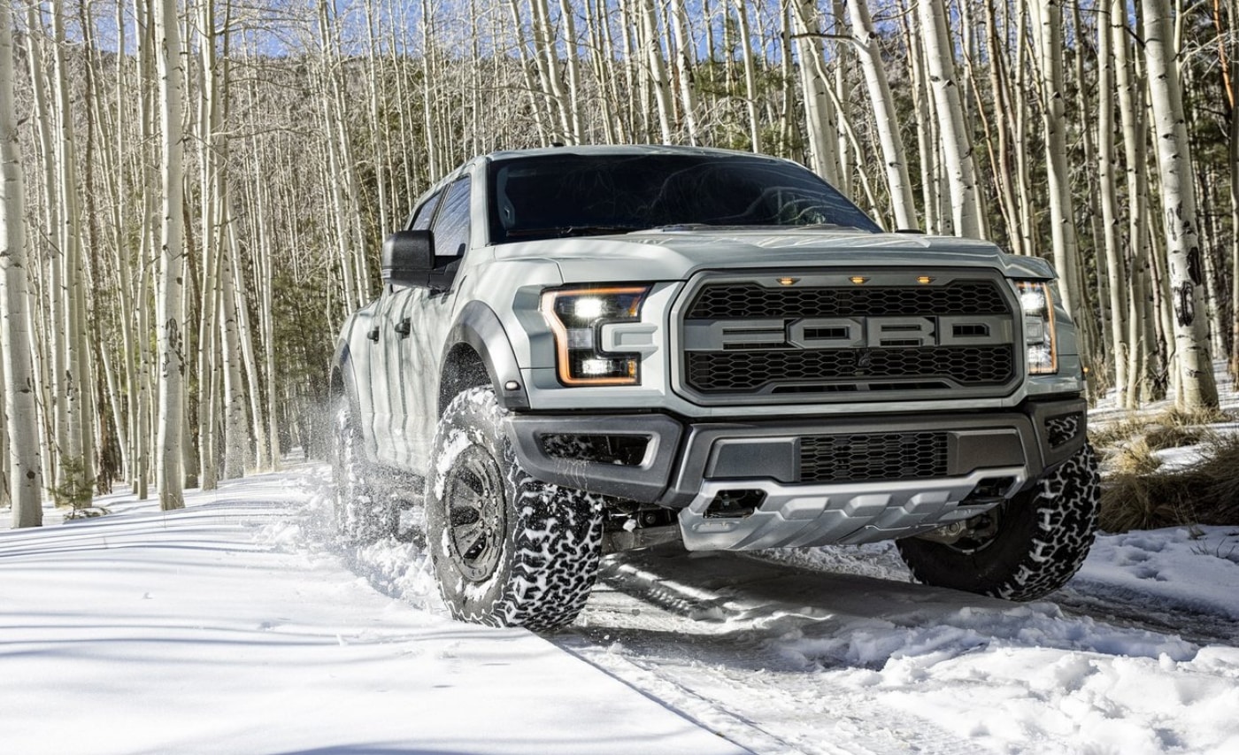 Used 2017 Ford Raptor parked in some thick snow in a forest of Colorado aspen trees