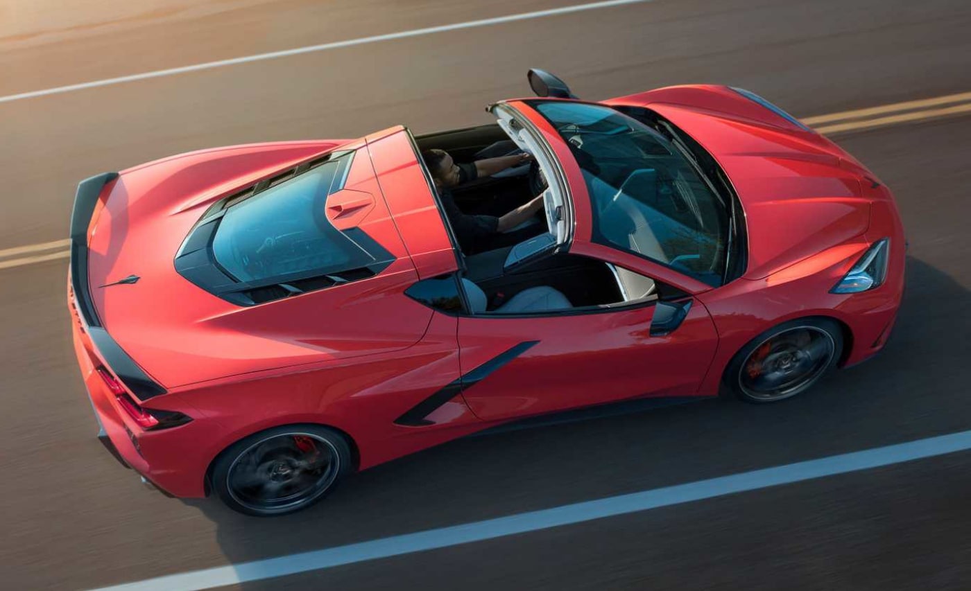 Aerial view of a red convertible Corvette Z06 driving at blazing speeds down an open highway