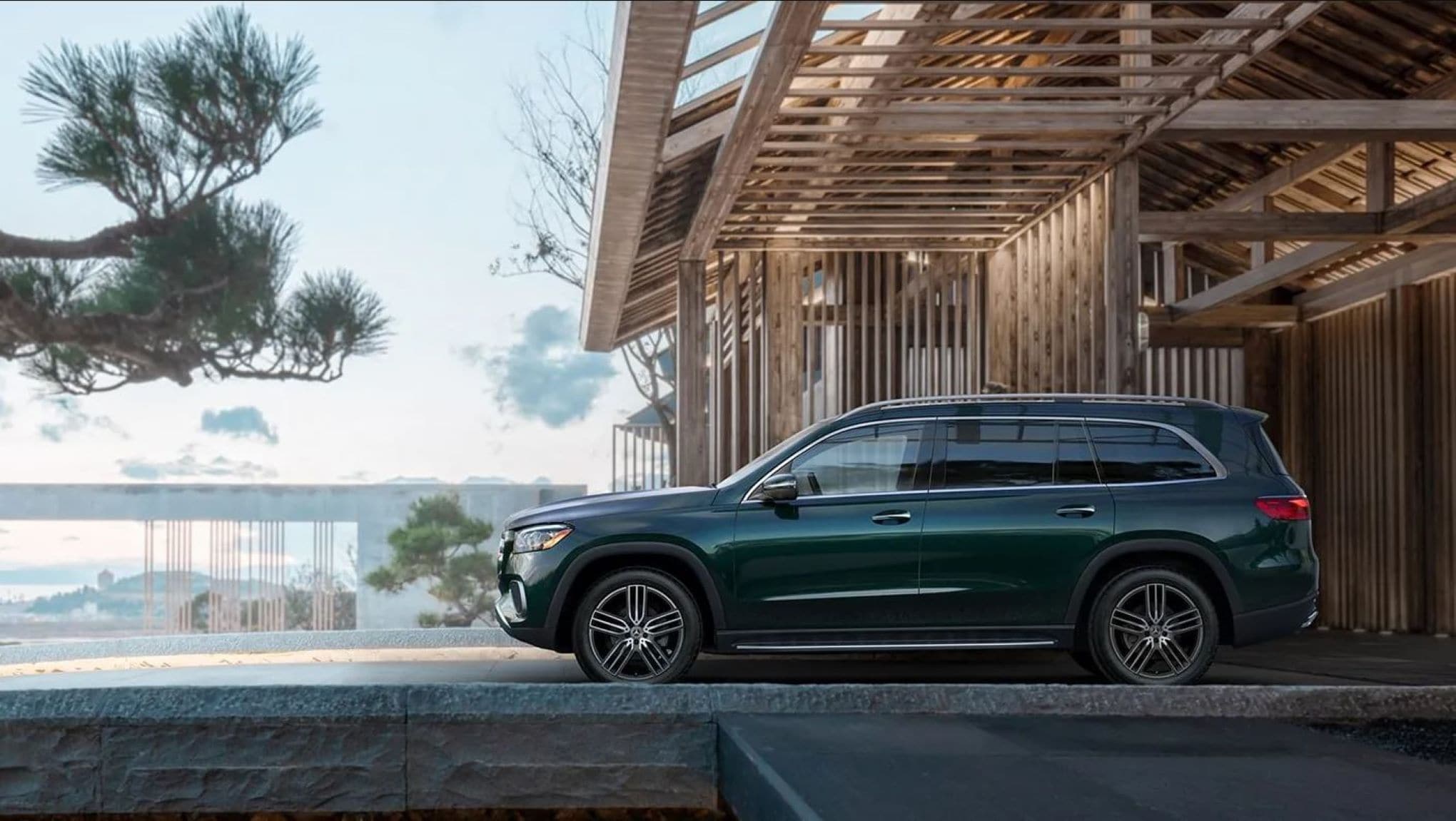 A Mercedes-Benz GLS parked in front of a modern building.