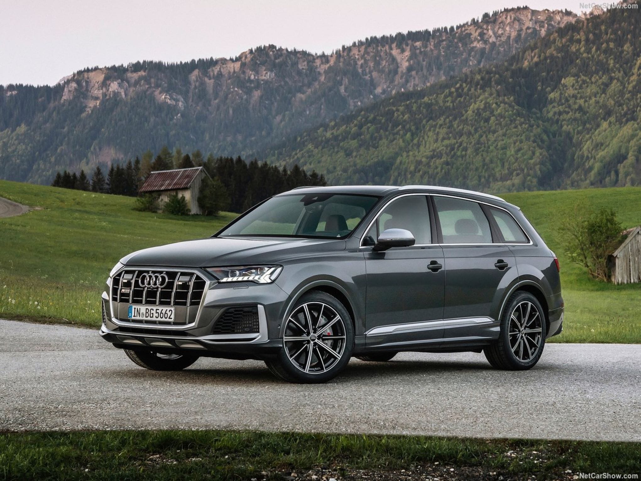 An Audi SQ7 parked with mountains in the background.