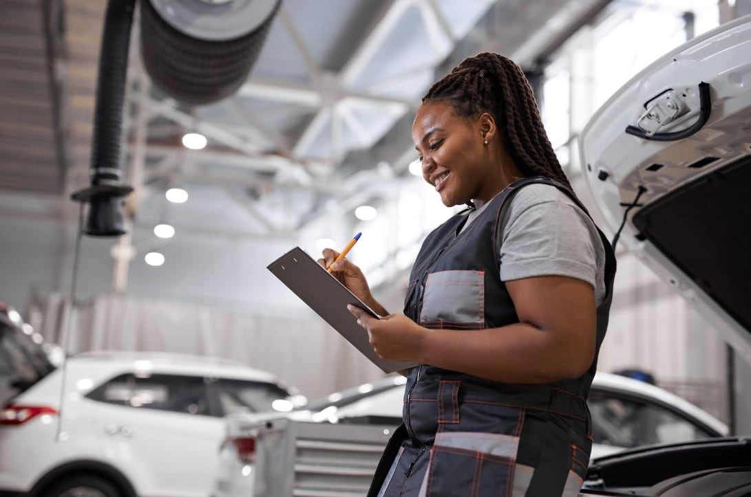 A certified technician working on a vehicle's engine at Phil Long Hyundai.
