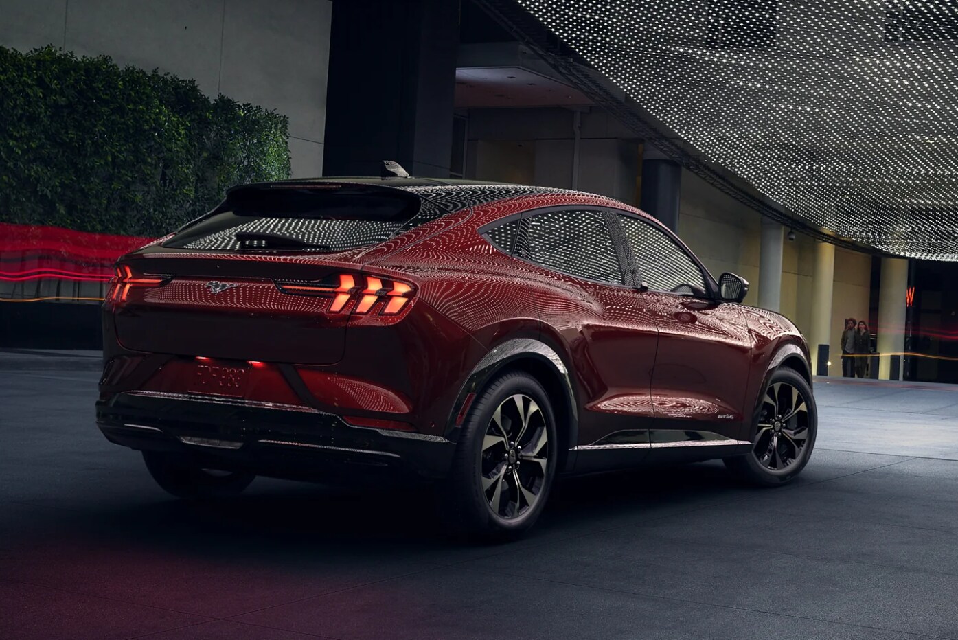 A view of the back of a dark red 2023 Ford Mustang Mach-E