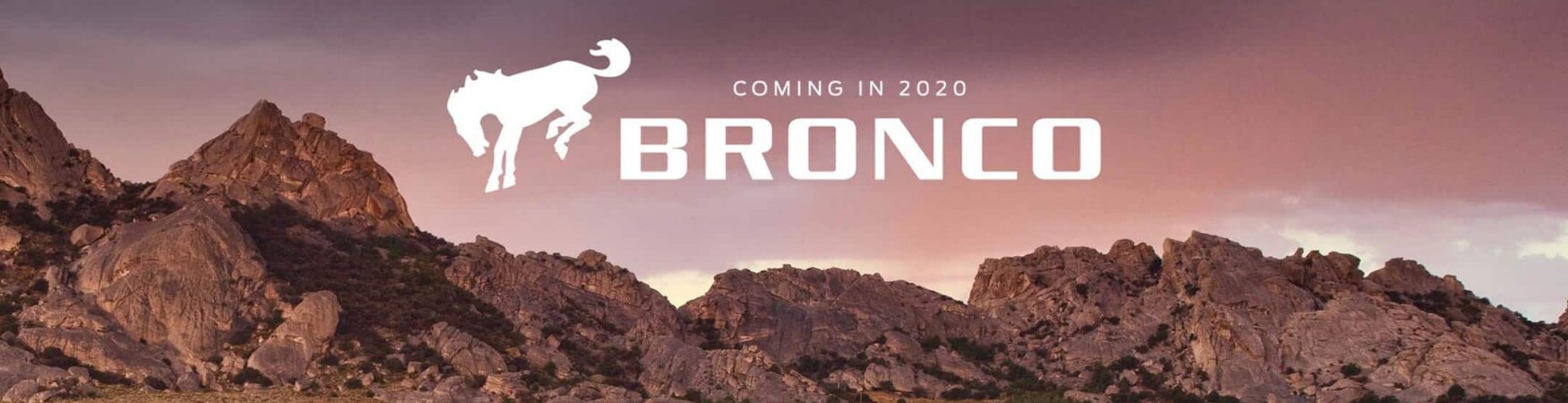 2020 Ford Bronco Billboard in Colorado Springs Phil Long.png 2020 Ford Bronco promotion billboard mountain range Bronco logo in the sky
