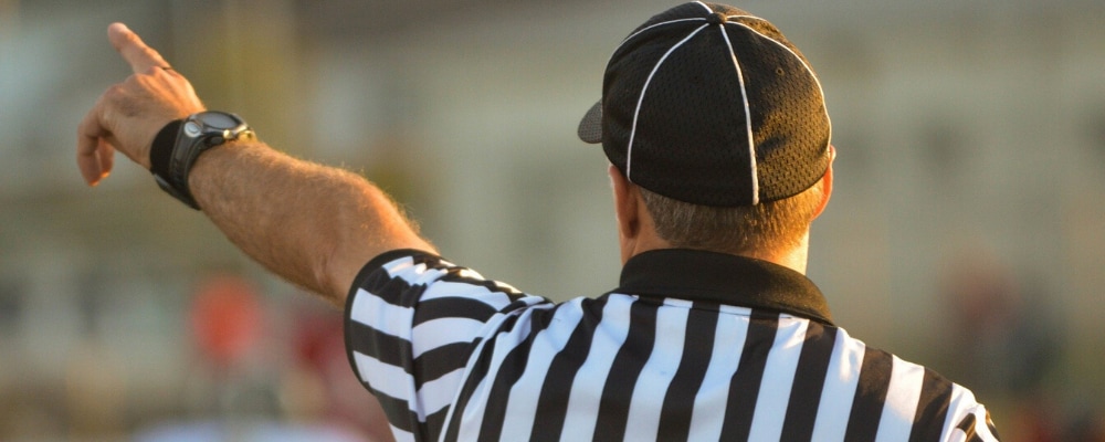 Football referee calling foul on the play when used car dealerships don't display window stickers