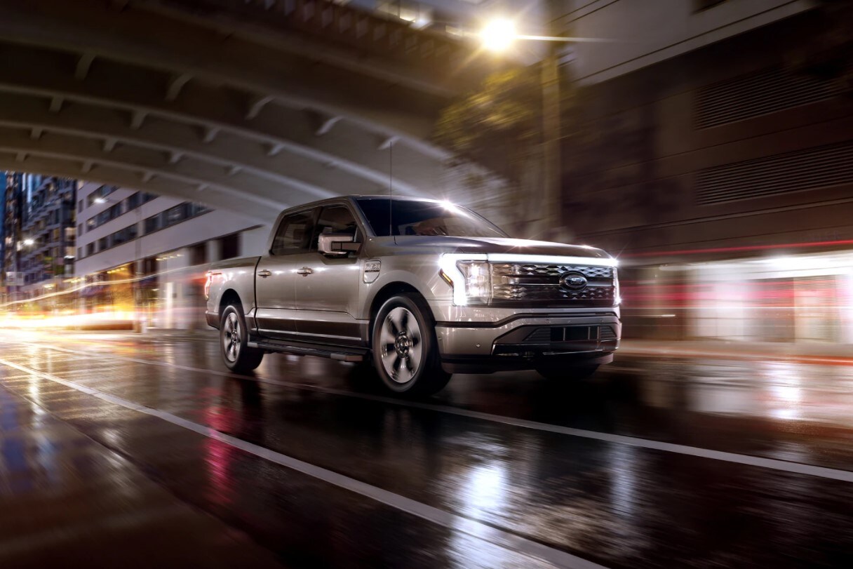 2022 Ford F-150 Electric Lightening driving on a street at night