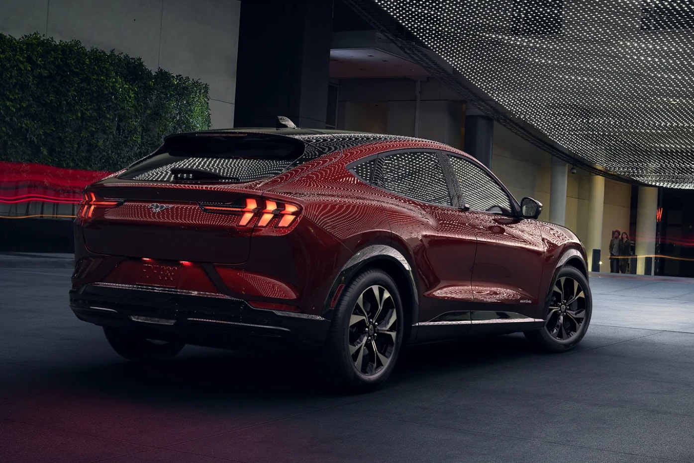 A view of the back of a dark red 2023 Ford Mustang Mach-E