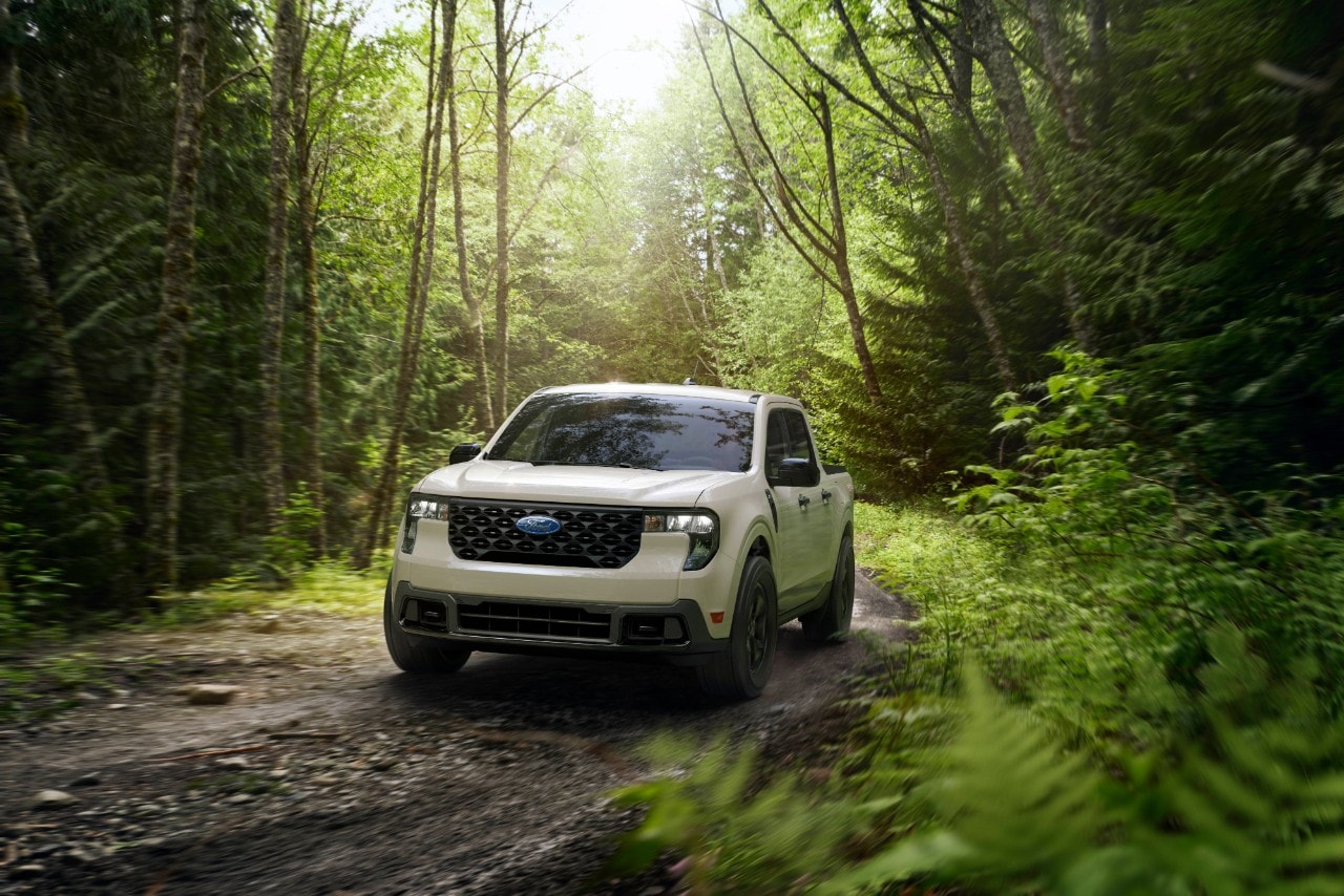 2025 Ford Maverick driving through the forest.