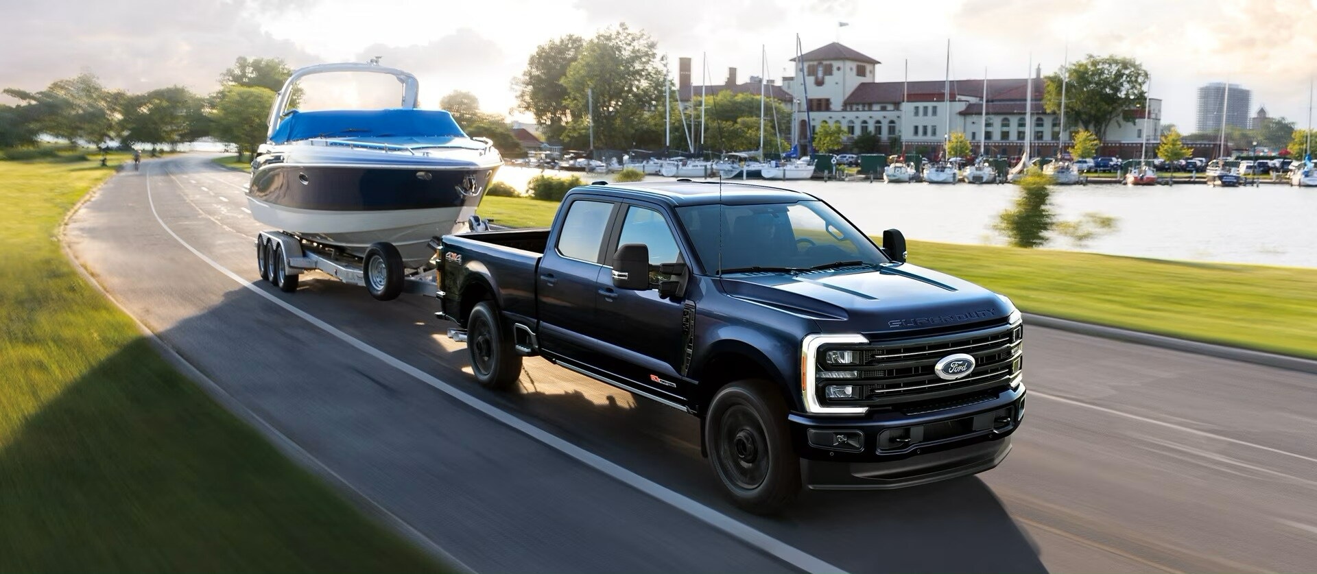 A dark blue Ford Super Duty towing a boat