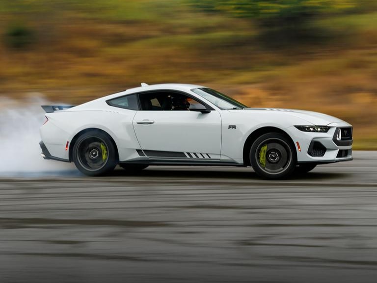 Two 2026 Ford Mustangs racing on a track