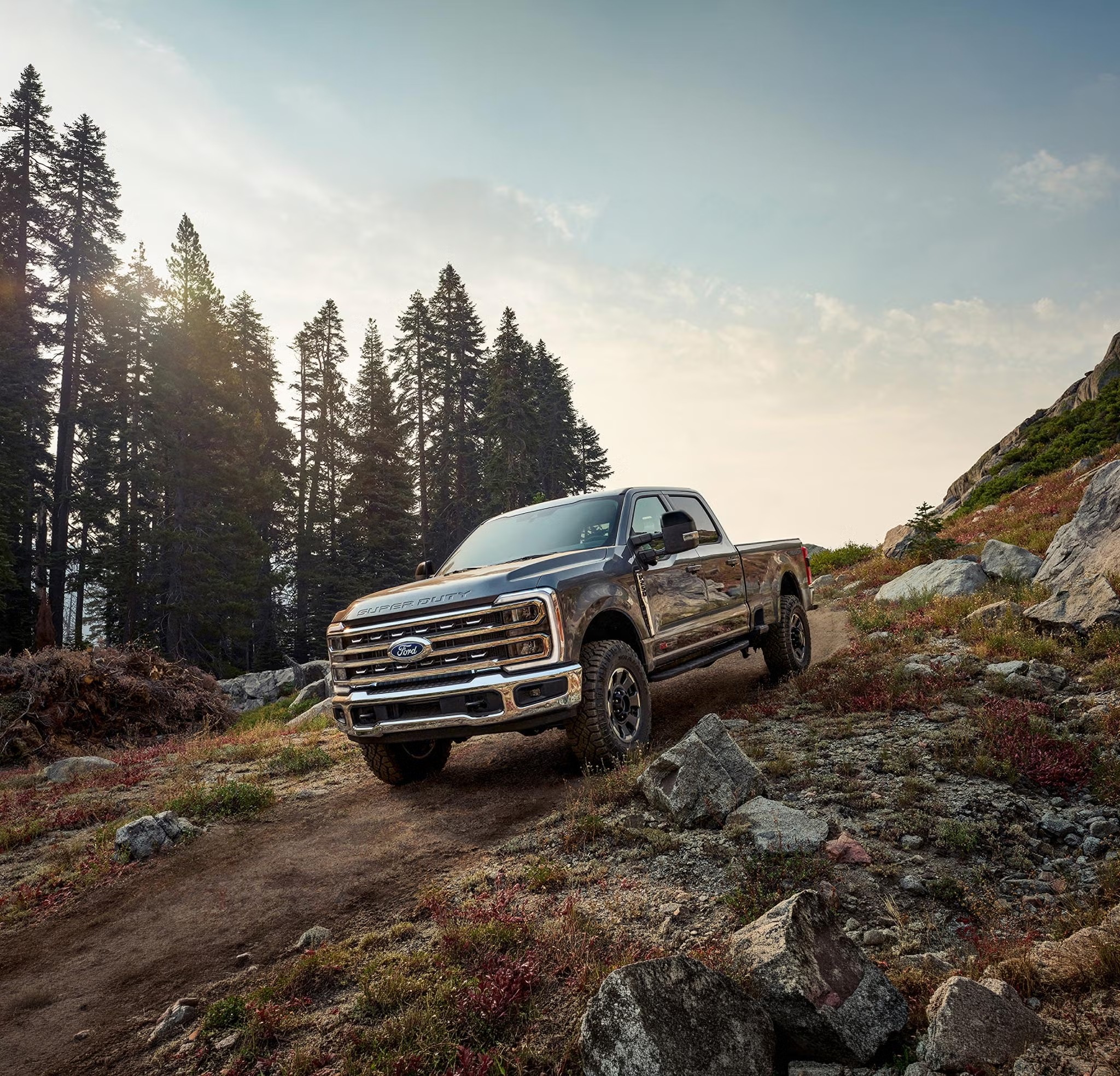 Ford Super Duty with off-road package climbing a rocky mountain trail