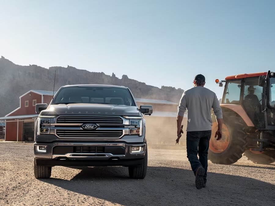 2025 Super Duty® hitched to a horse trailer with a horse and person at the back.