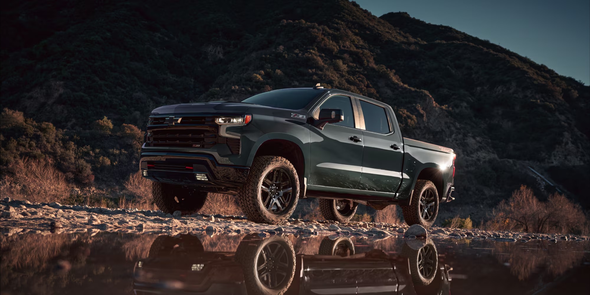 2026 Chevy Silverado Trail Boss parked beside water at dusk