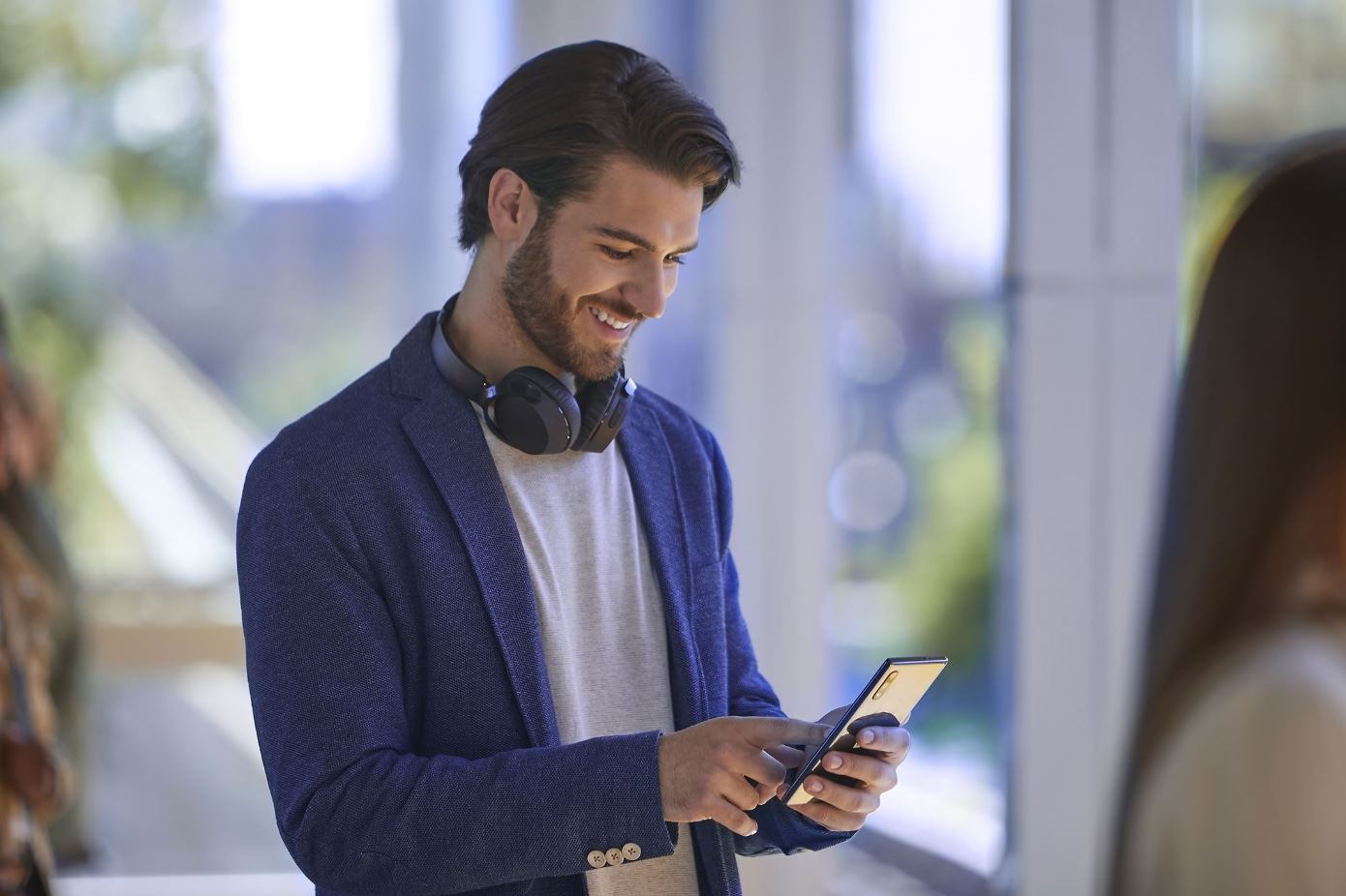 A man checks his FordPass Rewards account on his phone