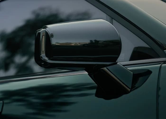 Close-up of the gloss black side mirror and dark green paint on the 2027 Hyundai Palisade Hybrid