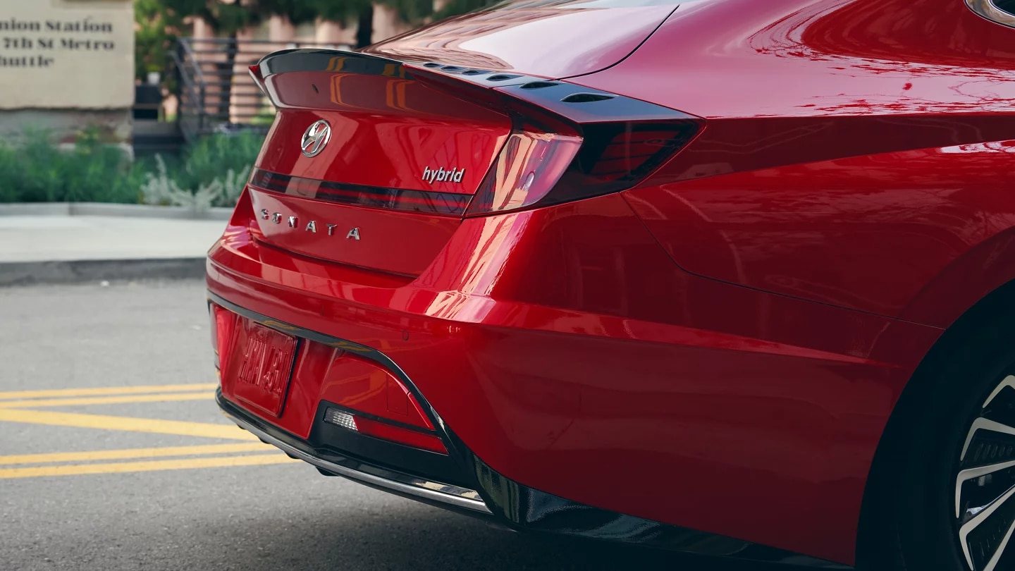 A closeup of the rear and back fender of a red 2023 Hyundai Sonata Hybrid
