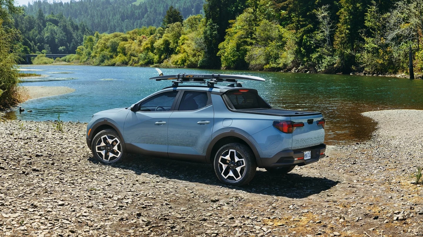 The All-New 2023 Hyundai Santa Cruz hauling a surf board The All-New 2022 Hyundai Santa Cruz Highway Driving