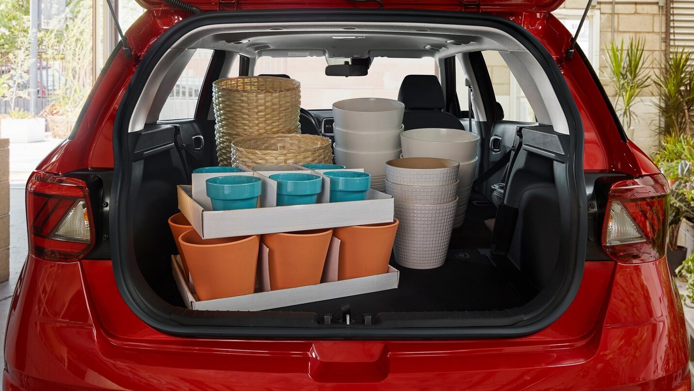 A view of the spacious cargo area of a red 2022 Hyundai Venue filled with planters of various sizes