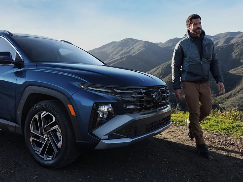 2026 TUCSON front three-quarter on a mountain road