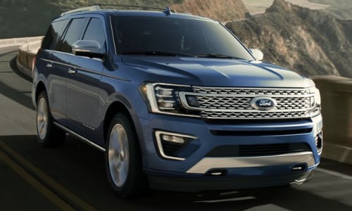 2020 Ford Expedition blue driving in-motion bridge mountain pass