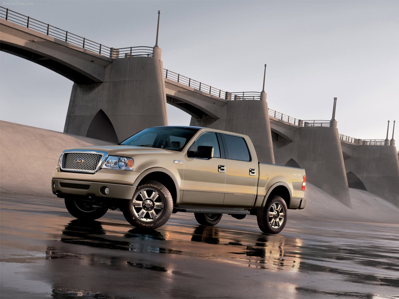 A brown 2006 Ford F-150 with a dam in the background.