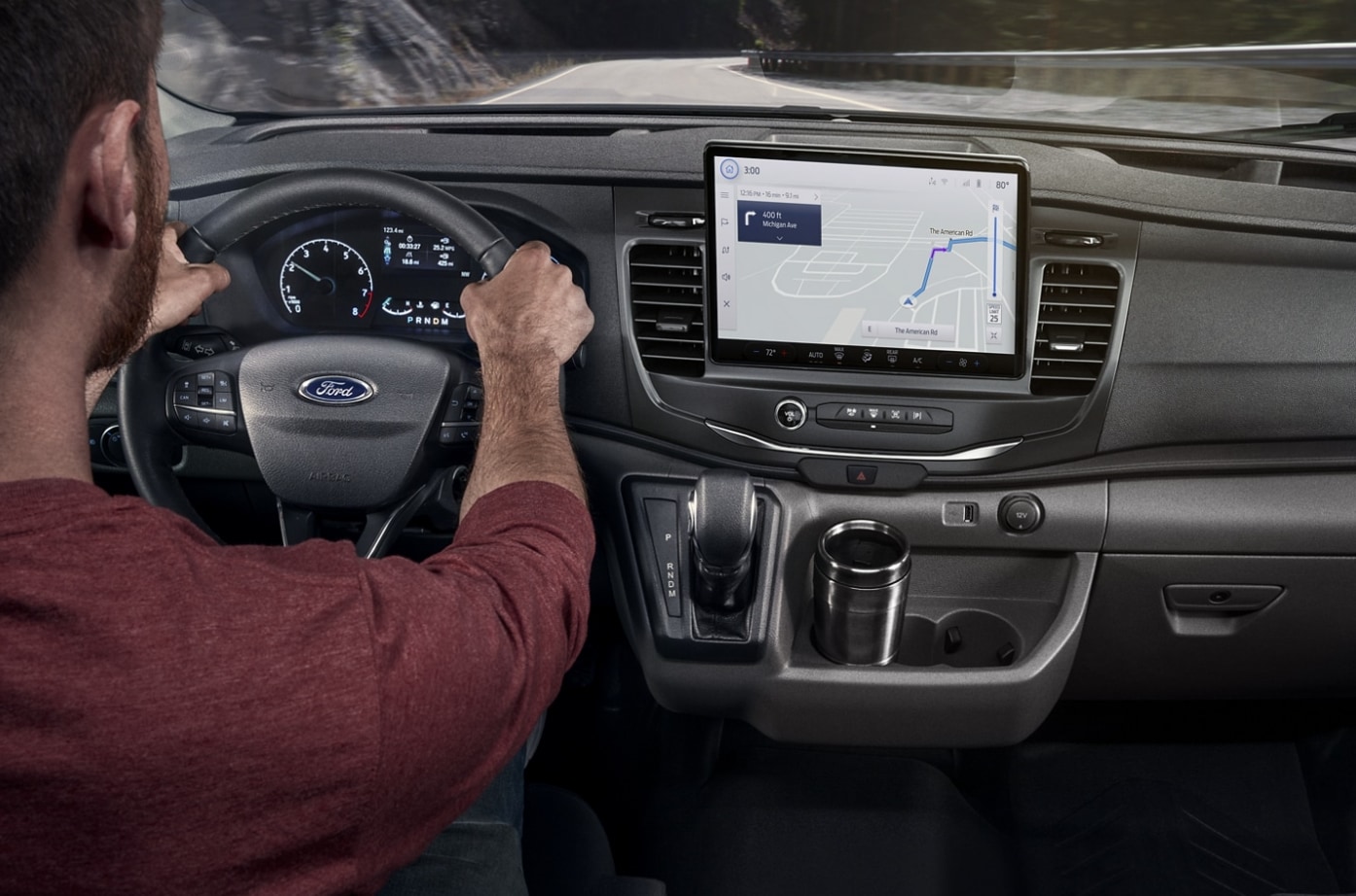 A man driving a 2023 Ford Transit Van and a view of the infotainment system and dash