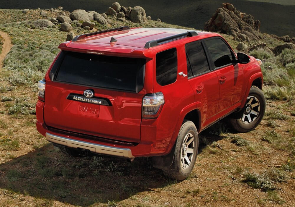 2020 Toyota 4Runner TRD Off-Road parked near a hill cliff in red exterior color