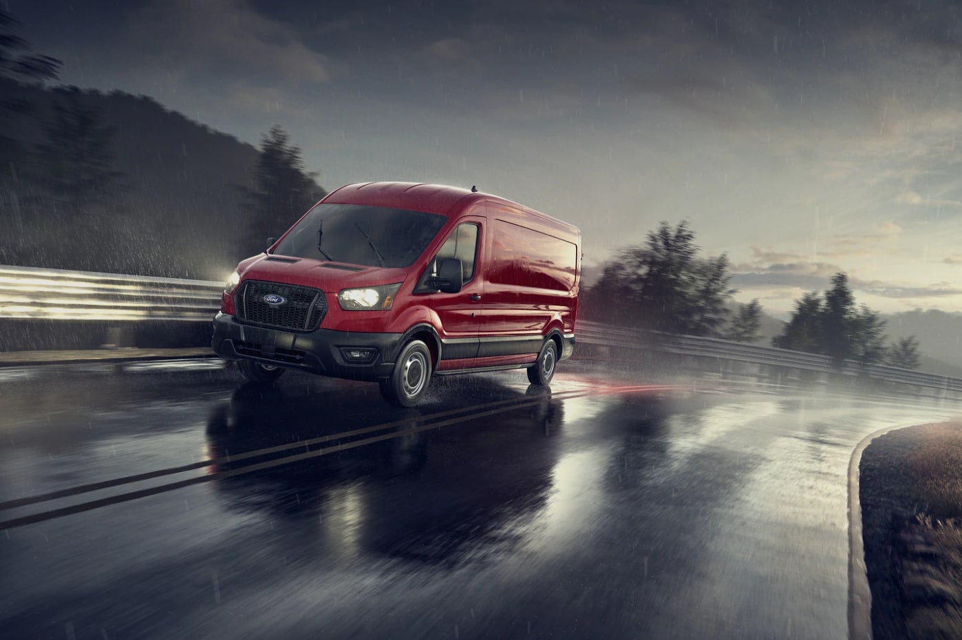 A red 2023 Ford E-Series van driving down a street