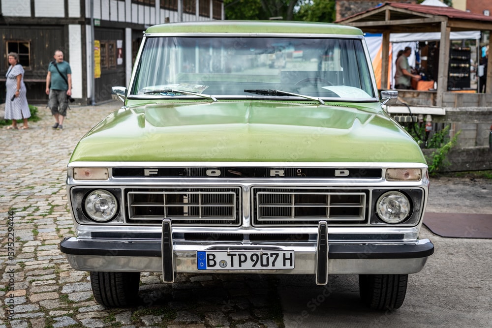 A front view of a classic green Ford F-150 Rnager.