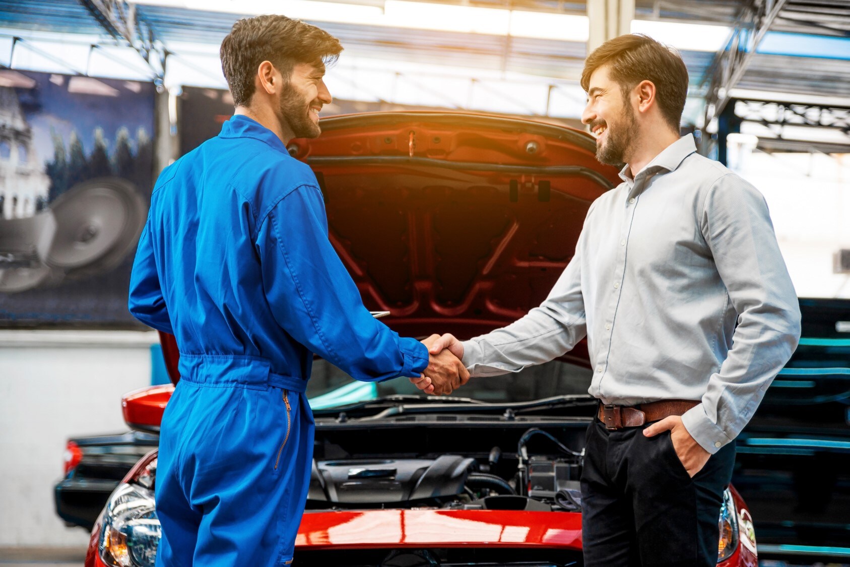 A mechanic shaking hands with a customer.